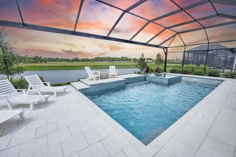 Screened pool and spa with an unobstructed lake view at a Vivid Shores model home