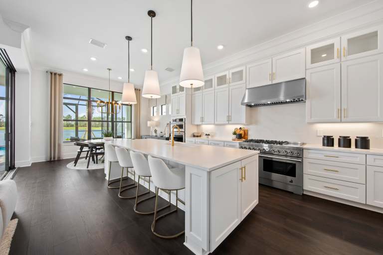 Brixton model home — chef's kitchen with large island and professional gas range